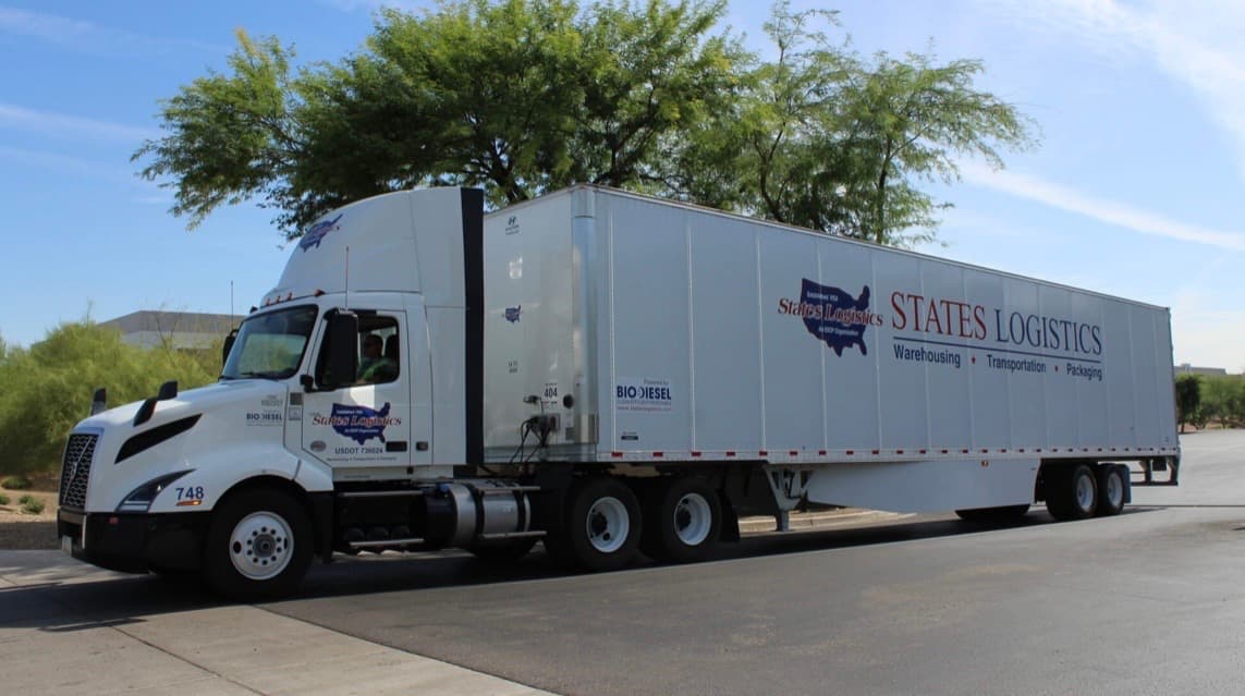 States Logistics semi-truck with trailer parked at a facility, showcasing warehousing, transportation, and packaging services.