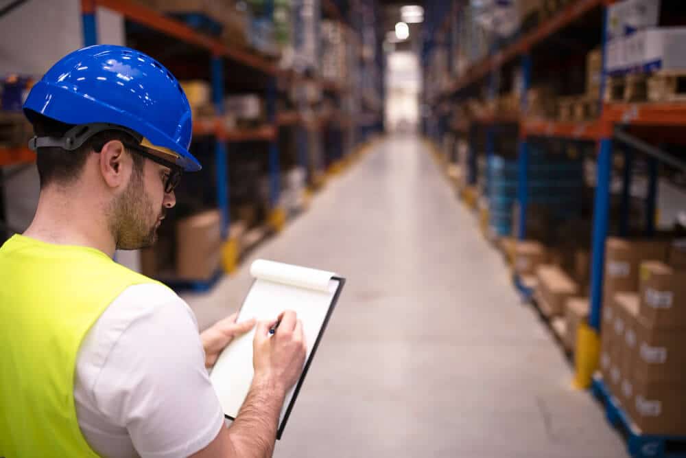 Factory Worker Holding Clipboard Checking Inventory Warehouse Storage Department