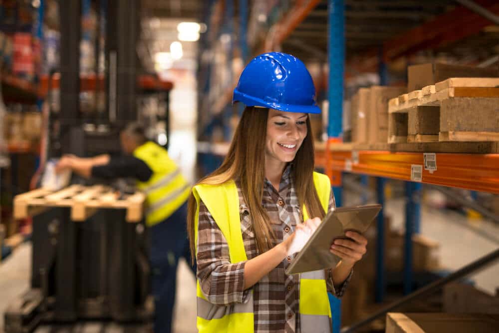 Female Warehouse Worker Holding Tablet Checking Inventory Distribution Warehouse