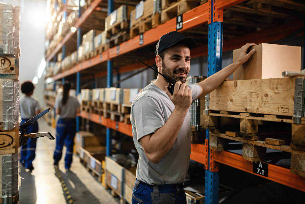 Happy Dispatcher Using Walkietalkie While Working Distribution Warehouse