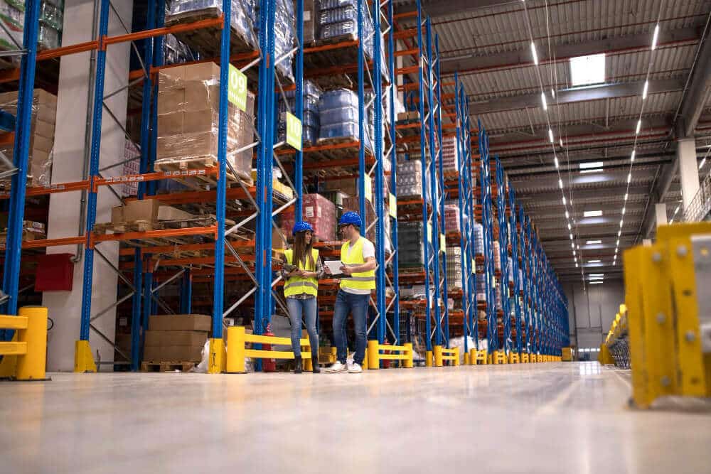 Warehouse Workers Discussing About Logistics Distribution Packages Market
