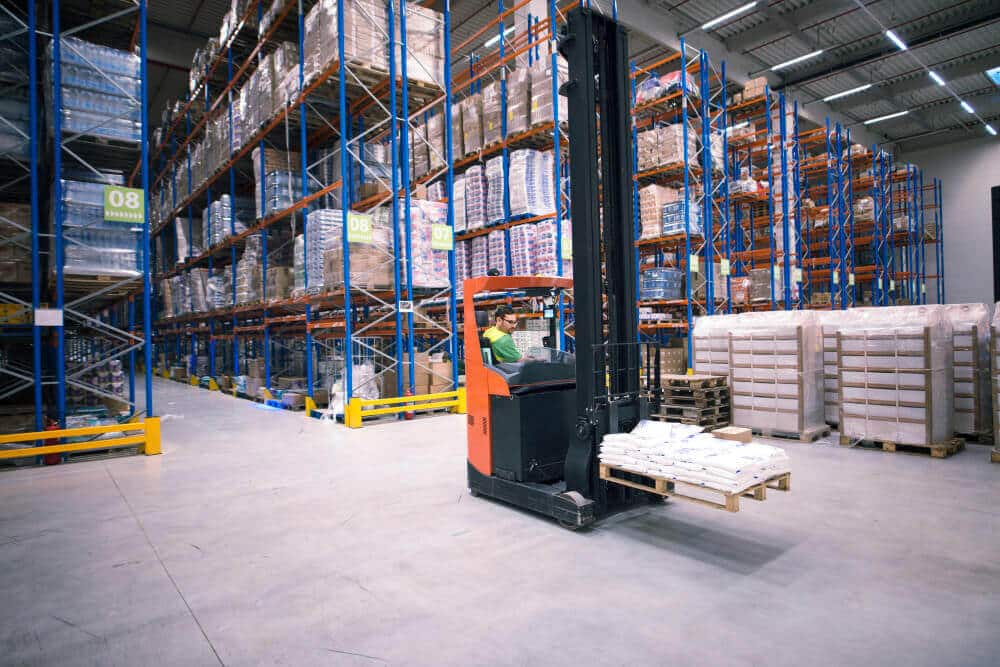 Worker Operating Forklift Machine Relocating Goods Large Warehouse Center